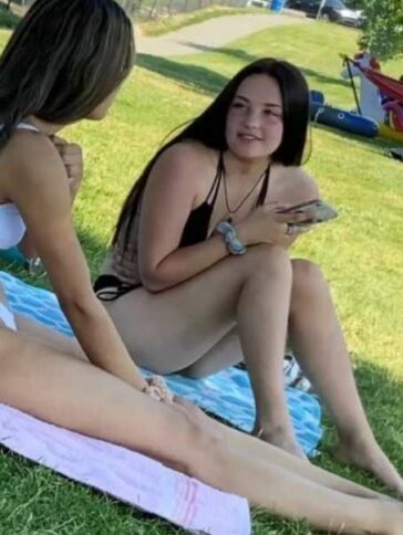 Two Teens Laying Down In Bikini