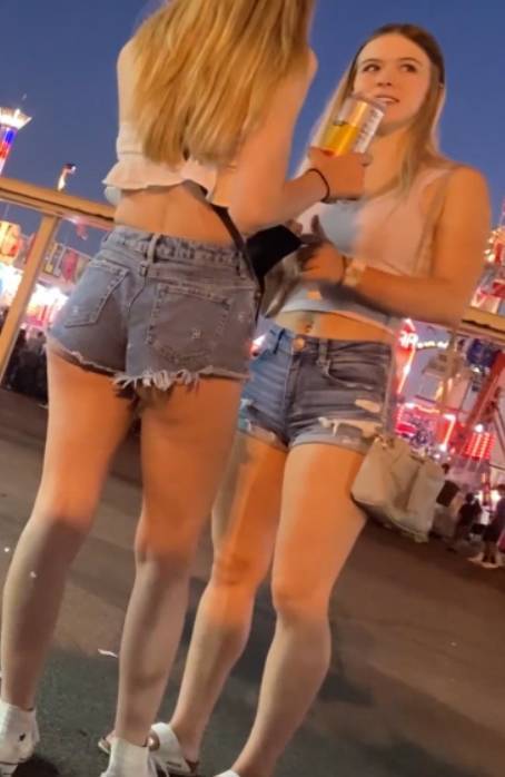 Two Teens In Shorts At Amusement Park